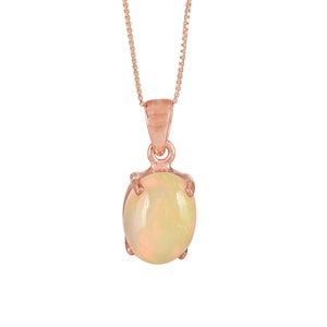 May include: A delicate rose gold chain necklace with a round opal pendant.