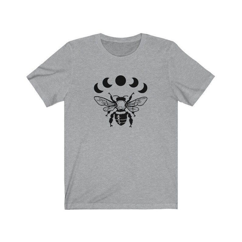 May include: A heather grey t-shirt with a black graphic of a bee with five crescent moons above it.