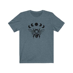 May include: A dark blue t-shirt with a black bee and five crescent moons graphic print.