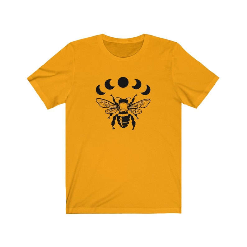 May include: A yellow short-sleeved t-shirt with a black bee and five crescent moons graphic print.