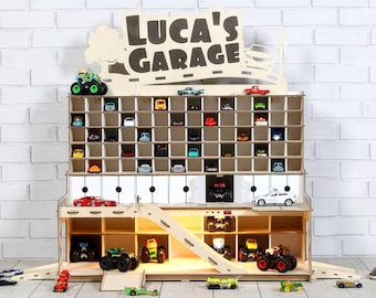 May include: Wooden toy garage with a ramp and multiple levels for storing toy cars. The garage is labeled "Luca's Garage" and has a light on the bottom level.