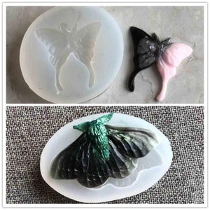May include: Two silicone moulds for making resin butterfly and moth jewellery. The moulds are clear and show the butterfly and moth shapes. The butterfly mould is round and the moth mould is oval.