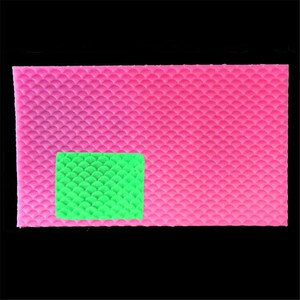 May include: Pink silicone baking mat with a raised, textured pattern of overlapping circles, resembling fish scales. A green section of the mat is highlighted to show the texture.