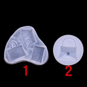 May include: Two silicone moulds for making resin crafts. The first mould has three handbag shapes. The second mould has one handbag shape.