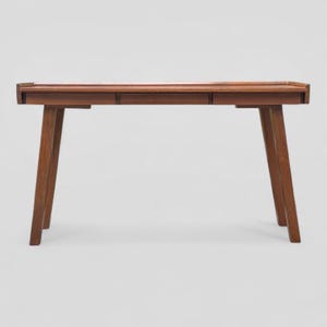 May include: A mid-century style desk in a rich brown hue. The desk has a rectangular top with a raised edge and three drawers. It is supported by four angled, tapered legs, offering a clean and minimalist design. The desk is approximately 120 cm long.