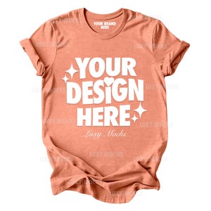 May include: A coral colored t-shirt with a white graphic that says "Your Design Here" and "Luxy Mocks".