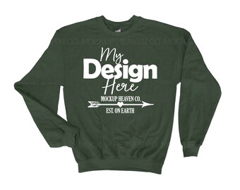 May include: A dark green sweatshirt with long sleeves and a crew neck. The sweatshirt has the text "My Design Here" in white, along with the text "MOCKUP HEAVEN CO. EST. ON EARTH" in white.