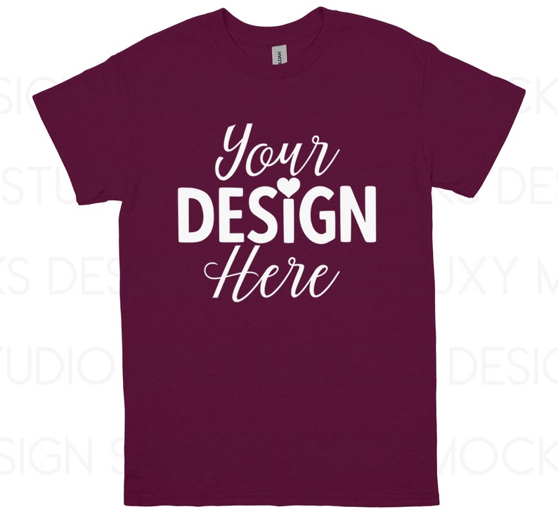 May include: A maroon t-shirt with the text "Your DESIGN Here" in white script. The design includes a small heart above the word "DESIGN". The shirt is a short-sleeved crew neck.