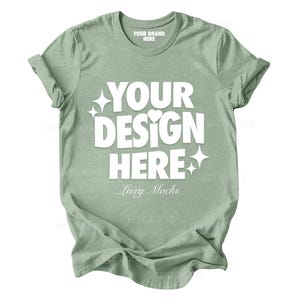May include: A sage green t-shirt with the text "YOUR DESIGN HERE" and "Luxy Mocks" printed on the front.