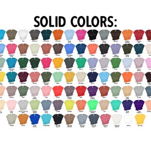 May include: A chart of 100 different solid color t-shirt options. The chart is labeled "SOLID COLORS:" and includes colors such as aqua, army, ash, asphalt, atlantic, autumn, baby blue, berry, black, blue storm, brown, burnt orange, cardinal, carolina blue, charity pink, chestnut, citron, clay, cocoa, columbia blue, cool blue, coral, dark grey, dark lavender, dark olive, deep teal, dust, dusty blue, electric blue, evergreen, forest, fuchsia, gold, hunter green, kelly, lavender blue, lavender dust, leaf, light blue, light violet, lilac, maize yellow, marine, maroon, mauve, military green, mint, mustard, natural, navy, ocean blue, olive, orange, orchid, oxblood, peach, pebble, pine, pink gravel, pink, poppy, purple storm, red, royal purple, rust, sage, sand dune, silver, slate, soft cream, soft pink, solid athletic grey, spring green, steel blue, storm, strobe, sunset, synthetic green, tan, teal, team navy, team purple, terracotta, thyme, violet, true royal, turquoise, vintage black, vintage brown, vintage denim, vintage navy, vintage red, vintage white, white, yellow.