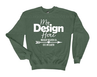 May include: A forest green sweatshirt with a white graphic that says "My Design Here" and "Mockup Heaven Co. Est. On Earth" with an arrow pointing to the right.