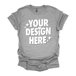 May include: A heather grey t-shirt with the text "YOUR DESIGN HERE" in white. The text is stylized with a heart and stars.