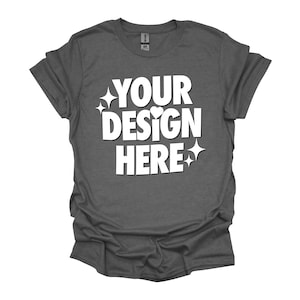 May include: A dark heather grey t-shirt with the text "YOUR DESIGN HERE" in white. The text is surrounded by small white stars and a heart.