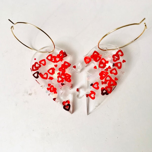 Handmade heart shape sparkly red ear rings, set in resin that fit together like puzzle pieces