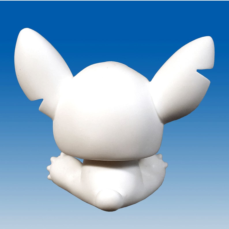 May include: White ceramic figurine of a cartoon character with large ears and a sitting pose.