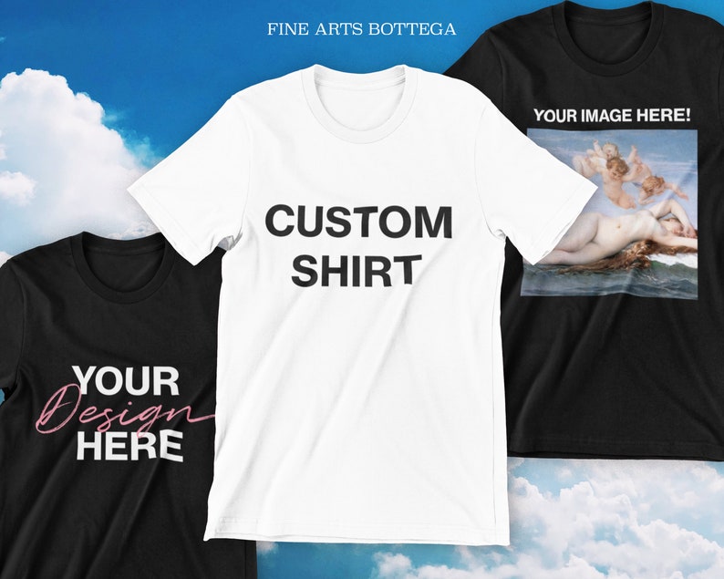 May include: Three t-shirts, one white, one black, and one black with a painting of a woman and two angels. The white t-shirt has the text "CUSTOM SHIRT" printed on it. The black t-shirt has the text "YOUR DESIGN HERE" printed on it. The black t-shirt with the painting has the text "YOUR IMAGE HERE!" printed on it.