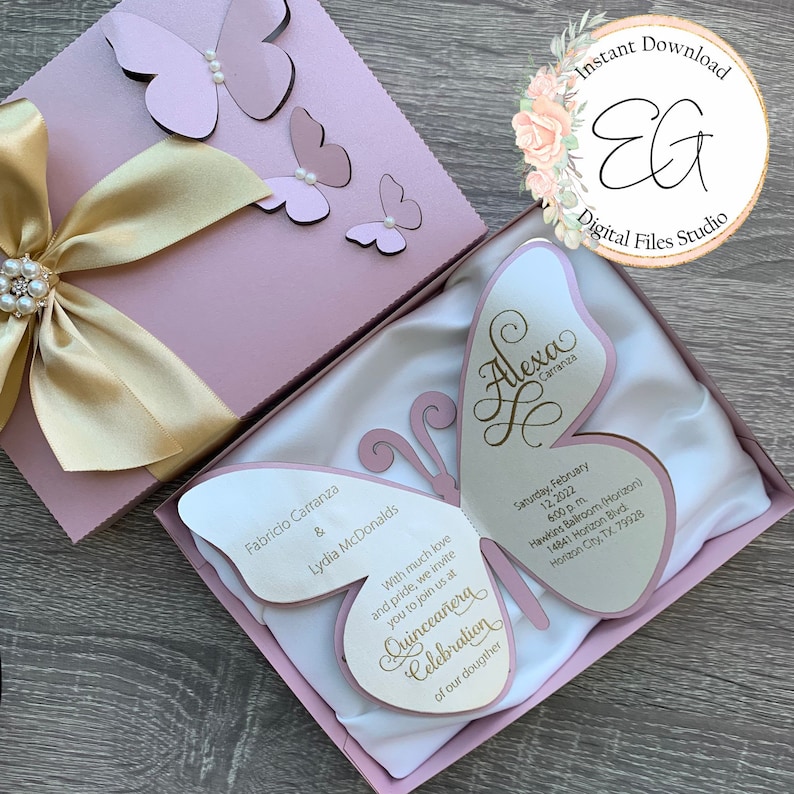 May include: A pink and gold butterfly-shaped invitation for a Quincea&ntilde;era celebration. The invitation features the name "Alexa Carranza" and the date "Saturday, February 12, 2022".
