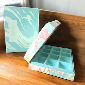 1986 Avon Flora Garden met stof beklede oorbel sieradendoosorganizer in originele doos, compartimentorganizer met pastel bloemenprint scharnierend deksel