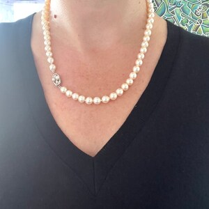 May include: A classic pearl necklace with a silver clasp. The pearls are white and round, and the necklace is approximately 18 inches long.