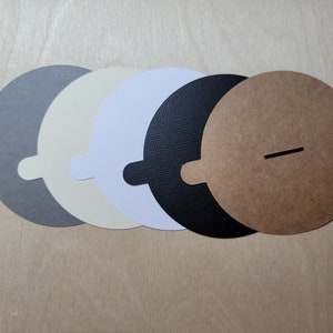 Overview of candle dust covers in a variety of color options, including black, white, cream, gray, and kraft brown. Wood wick options are featured.