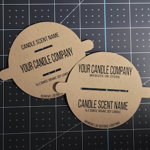 Sample photo of horizontal wood wick and double vertical wood wick custom candle dust covers in kraft cardstock with black printing. Example text includes candle scent name, your candle company, and remove lid before lighting text.