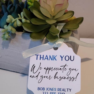 Custom tags for products, gifts, and special occasions. Shown: white tag for thank you gift - real estate agent. Customize with your own text. Precision cut and individually designed for your needs. Premium cardstock in white, cream, gray, kraft.