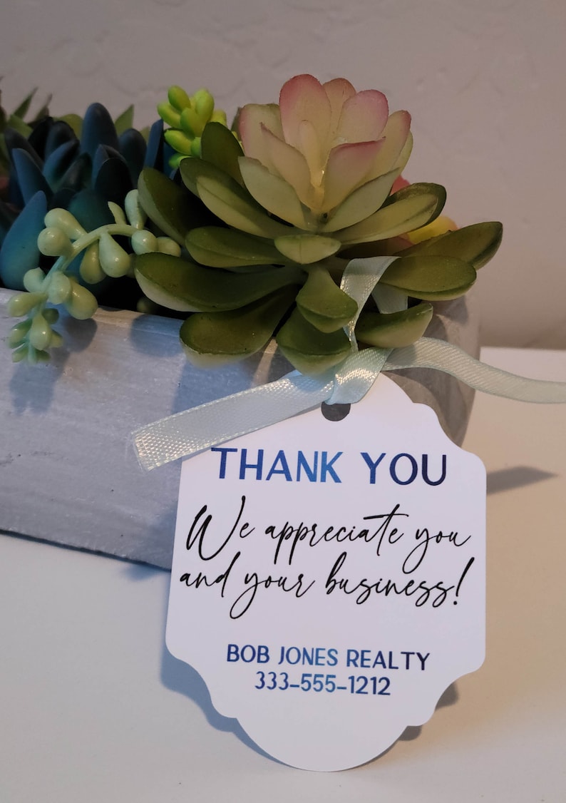 Custom tags for products, gifts, and special occasions. Shown: white tag for thank you gift - real estate agent. Customize with your own text. Precision cut and individually designed for your needs. Premium cardstock in white, cream, gray, kraft.
