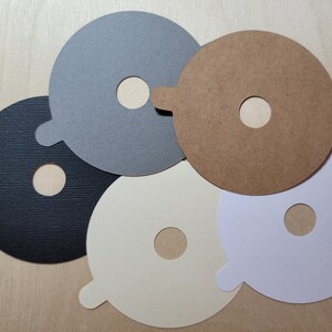 Overview of candle dust covers in a variety of color options, including black, white, cream, gray, and kraft brown.