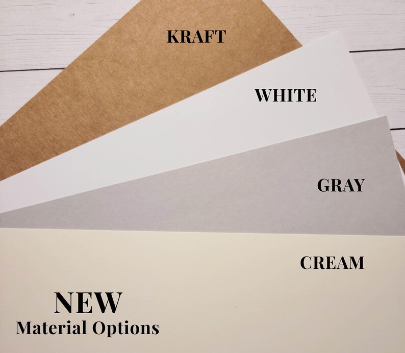 Photo showing the new and old versions of the kraft cover stock materials used for making custom candle dust covers. The newer version is a couple of shades darker and is actually more of a "true" kraft color.