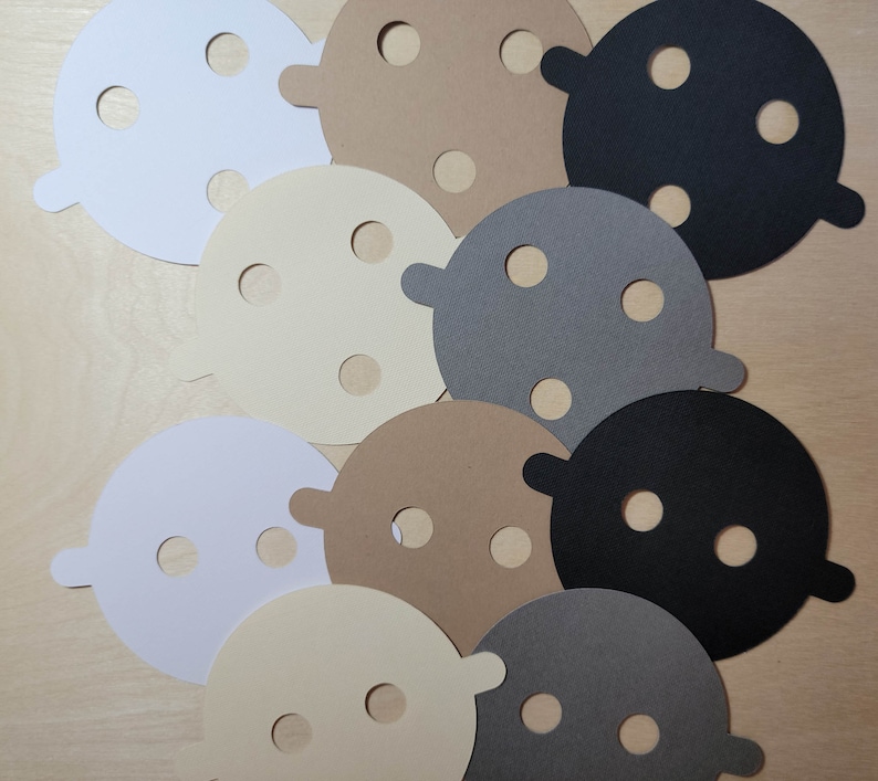 Overhead view of candle dust covers in black, gray, white, and cream on a wood background. Standard and wood wick options.