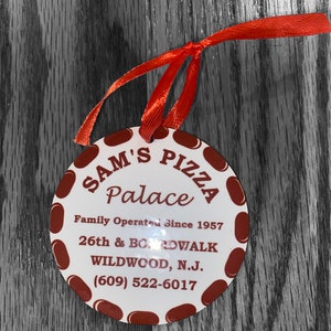 May include: A white round sign with red polka dots and the text "SAM'S PIZZA Palace Family Operated Since 1957 26th & BOARDWALK WILDWOOD, N.J. (609) 522-6017".