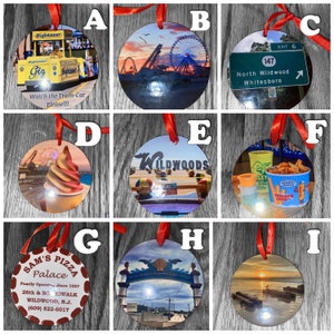 May include: Nine round ornaments with various images of the Wildwood, New Jersey boardwalk. The ornaments feature images of the tram car, the Ferris wheel, the beach, and a sign for North Wildwood. The ornaments are decorated with red ribbons.