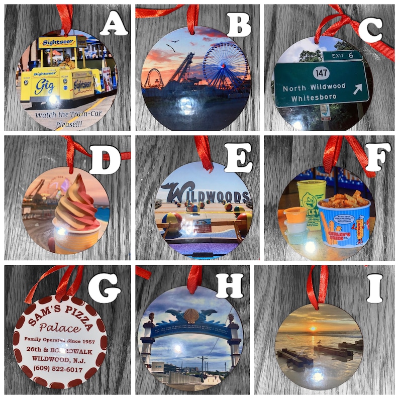 May include: Nine round ornaments with various images of the Wildwood, New Jersey boardwalk. The ornaments feature images of the tram car, the Ferris wheel, the beach, and a sign for North Wildwood. The ornaments are decorated with red ribbons.