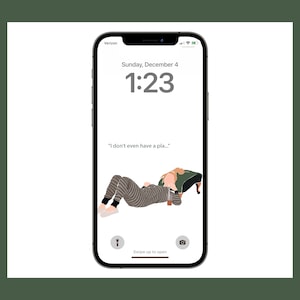 May include: A smartphone screen displaying a digital clock with the time 1:23 and the date Sunday, December 4. The text "I don't even have a pla..." is displayed below the clock. A cartoon illustration of a person in pajamas lying on a couch is shown on the screen.