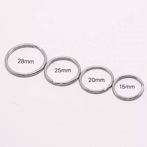 May include: Four silver key rings of different sizes. The rings are labelled with their diameters: 28mm, 25mm, 20mm, and 15mm.