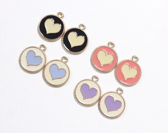 May include: Eight gold-tone heart charms with different colored enamel hearts. The charms have a scalloped edge and a loop for attaching to jewelry.