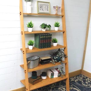 May include: A rustic wooden sign with the text "Welcome to our home" in white lettering. The sign features a distressed finish and a simple, inviting design, perfect for entryway decor.