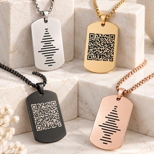 May include: Four dog tag pendants on box chains. One silver tag features a black sound wave graphic, one gold tag has a black QR code, one black tag displays a white QR code, and one rose gold tag shows a black sound wave graphic design.