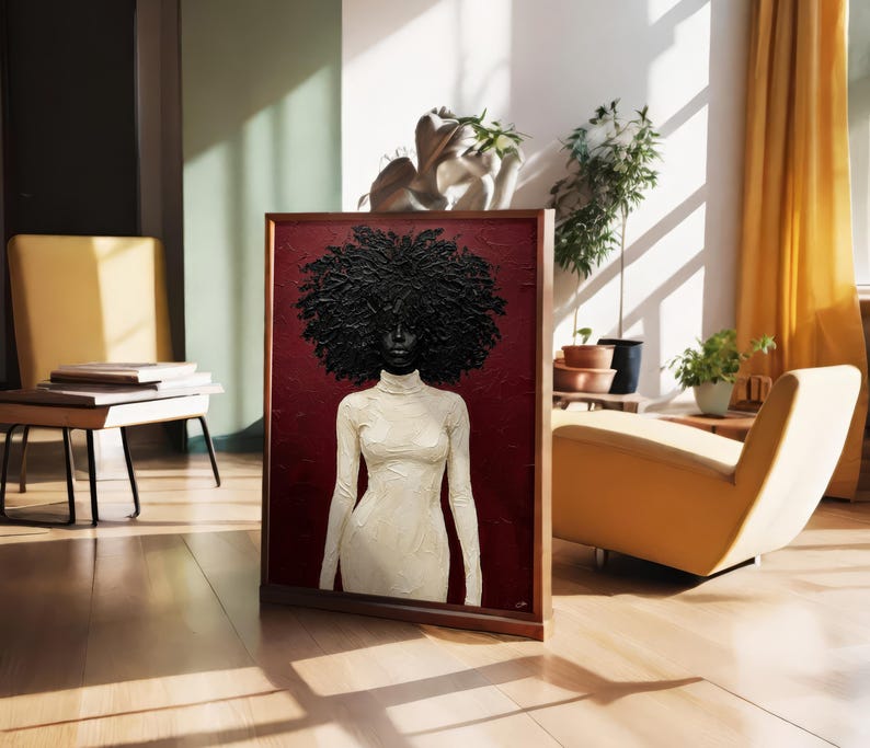 May include: A framed artwork featuring a portrait of a person with a large, textured black afro and a white turtleneck dress against a deep red background. The artwork is displayed in a well-lit room with a wooden floor.