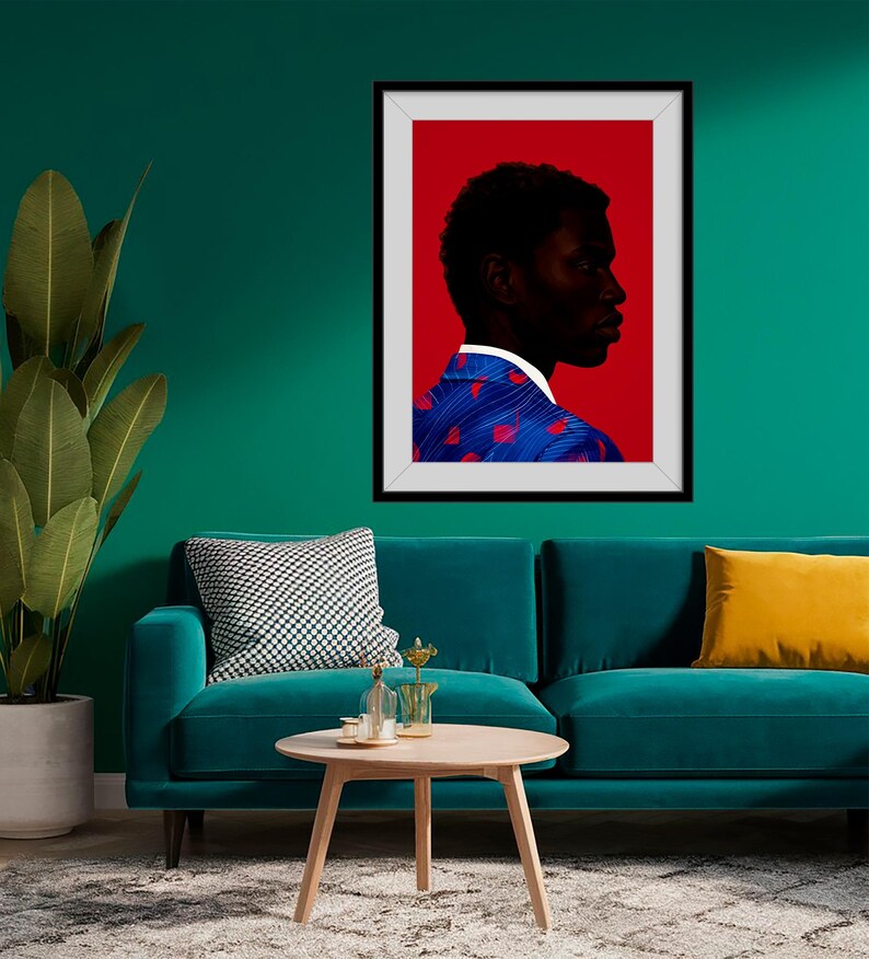 May include: A framed art print featuring a profile portrait of a person against a red background. The person is wearing a blue jacket with red heart-shaped patterns. The artwork is displayed on a teal wall above a teal sofa.