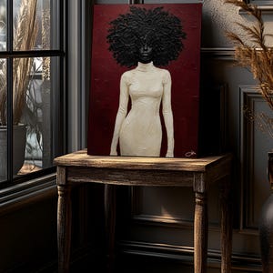 May include: An art print on a wooden table. The artwork features a woman with a large afro and a white turtleneck dress against a burgundy background. The table is made of dark wood and has four legs. The room has a window and decorative elements.