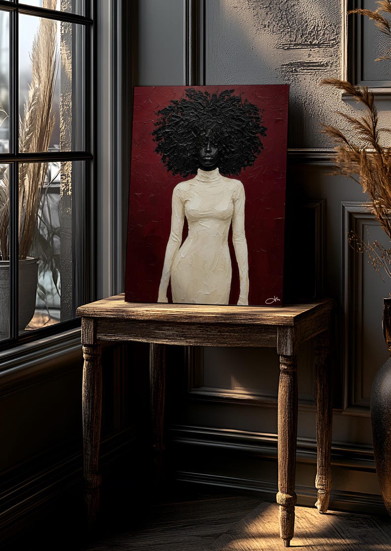 May include: An art print on a wooden table. The artwork features a woman with a large afro and a white turtleneck dress against a burgundy background. The table is made of dark wood and has four legs. The room has a window and decorative elements.