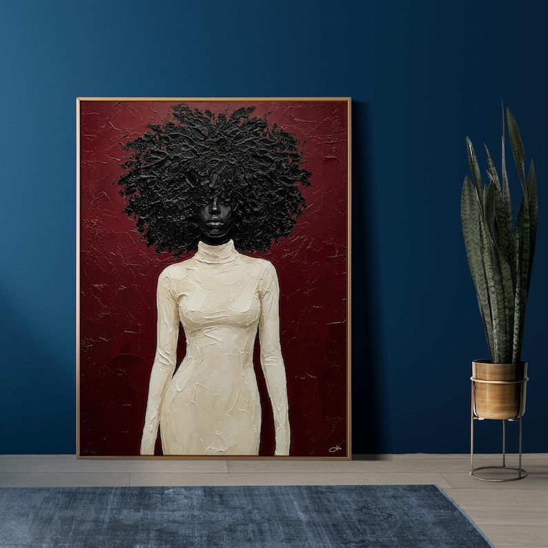 May include: A framed painting featuring a woman with a large, textured black afro and a cream-colored turtleneck dress. The background is a deep red, and the artwork is set against a dark blue wall. A tall plant in a gold pot is to the right.