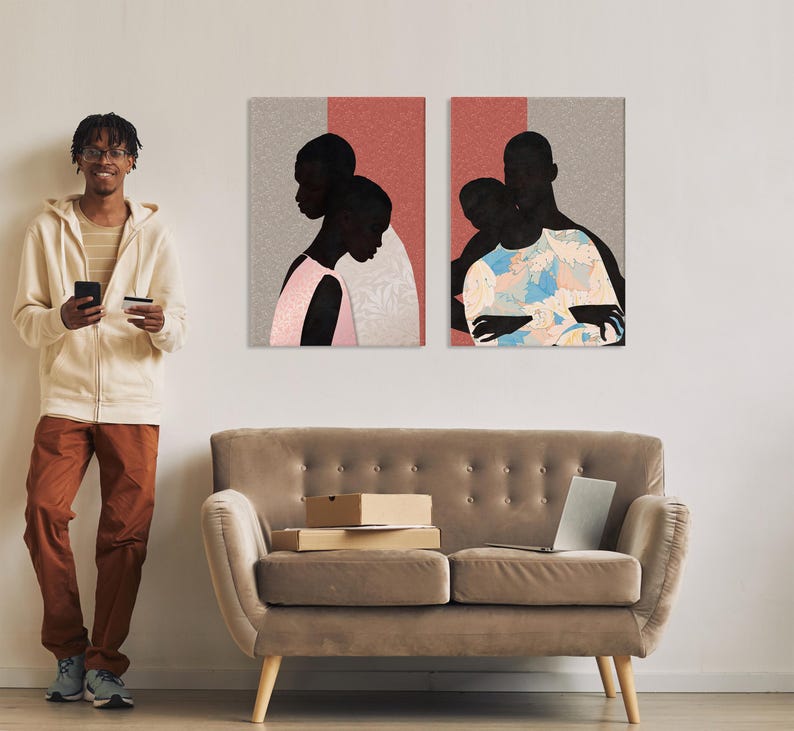 May include: Two rectangular wall art prints featuring stylised silhouettes of people against a split background of textured grey and solid coral. The left print shows a person in a pink top, while the right print depicts a person in a floral shirt.