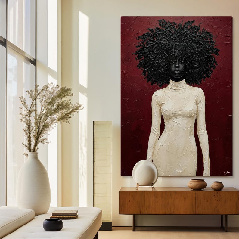 May include: A large, textured painting of a woman with a voluminous black afro and a cream-colored turtleneck dress against a deep red background. The artwork is displayed above a wooden cabinet.