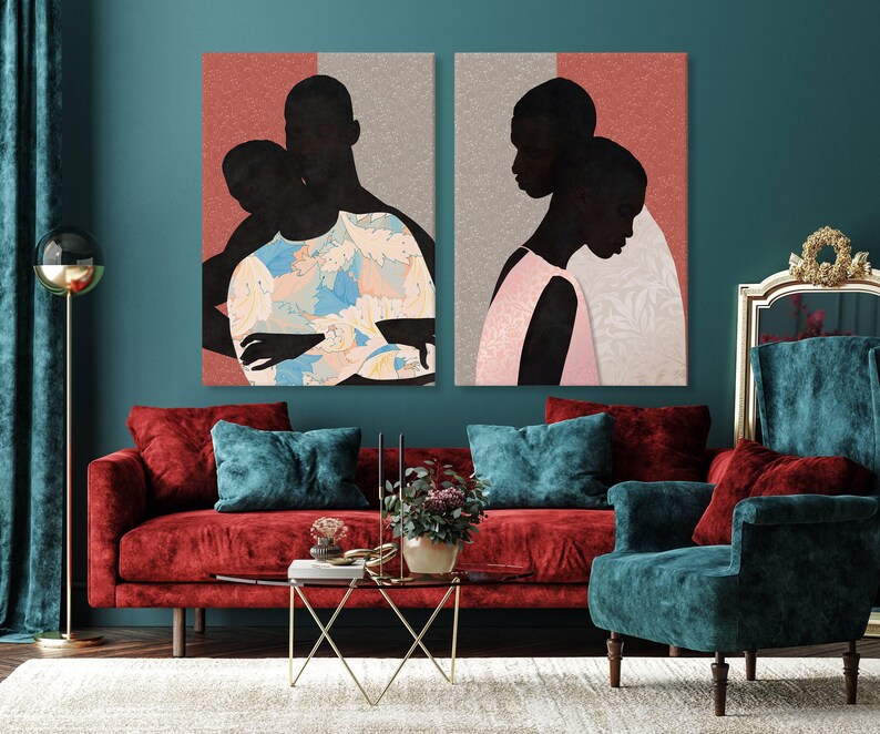 May include: Two rectangular wall art prints featuring stylised silhouettes of people. The left print shows two figures in a blue and white floral garment against a coral background. The right print depicts two figures in pink against a grey background.