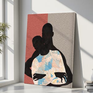 May include: A rectangular wall art print featuring the black silhouettes of two figures embracing. One figure wears a shirt with a light blue, peach, and white floral pattern. The background is split vertically between a textured terracotta and grey.