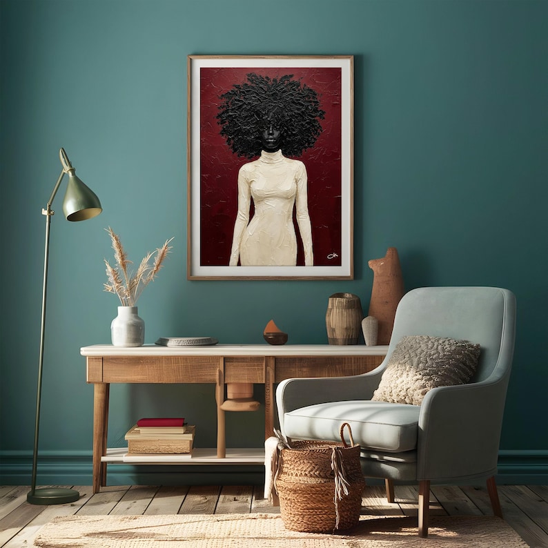 May include: Framed art print featuring a textured portrait of a person with a large, dark afro and wearing a cream-colored turtleneck dress. The background is a deep red, and the artwork is displayed in a room with teal walls and wooden furniture.