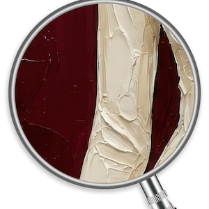 May include: Close-up of an abstract painting viewed through a magnifying glass. The artwork features thick brushstrokes of deep burgundy and creamy off-white, creating a textured, tactile appearance. The magnifying glass adds a sense of detail.