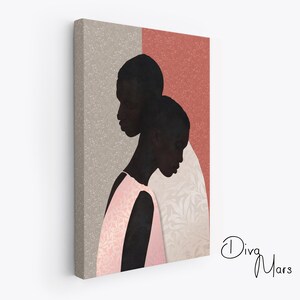 May include: A rectangular canvas print featuring a stylised illustration of two dark-skinned figures in profile against a split background of beige and terracotta. One figure wears a light pink patterned garment. The text Diva Mars is in the corner.